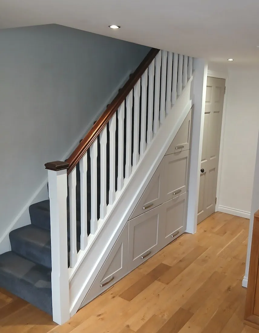 Custom under-stair storage by T M Joinery